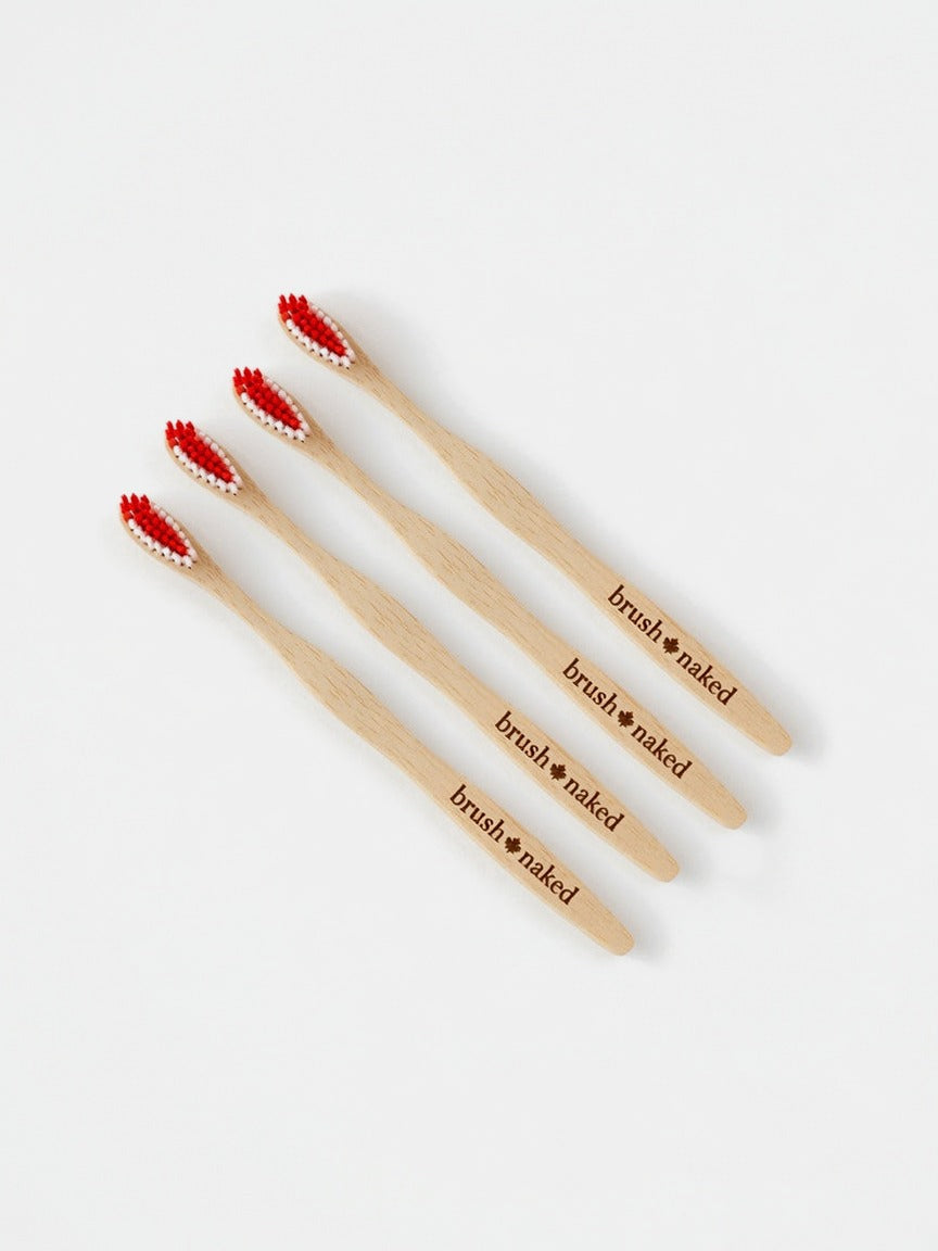 True North Maple Toothbrush 4-Pack - four Canadian-made maple toothbrushes with red and white bristles