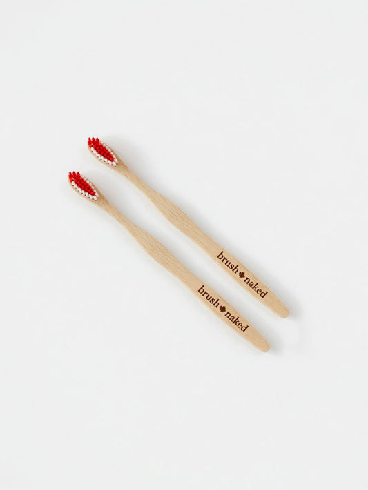 True North Maple Toothbrush 2-Pack Gift Set - two Canadian-made maple toothbrushes with red and white bristles